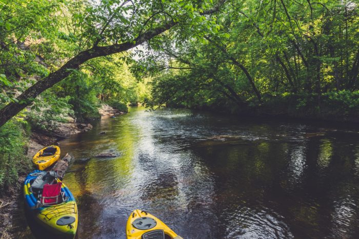 Kayaks line the river banks of the St. Croix River at Sandrock Cliff Campground near Grantsburg, Wisconsin. Photo: Tony Webster